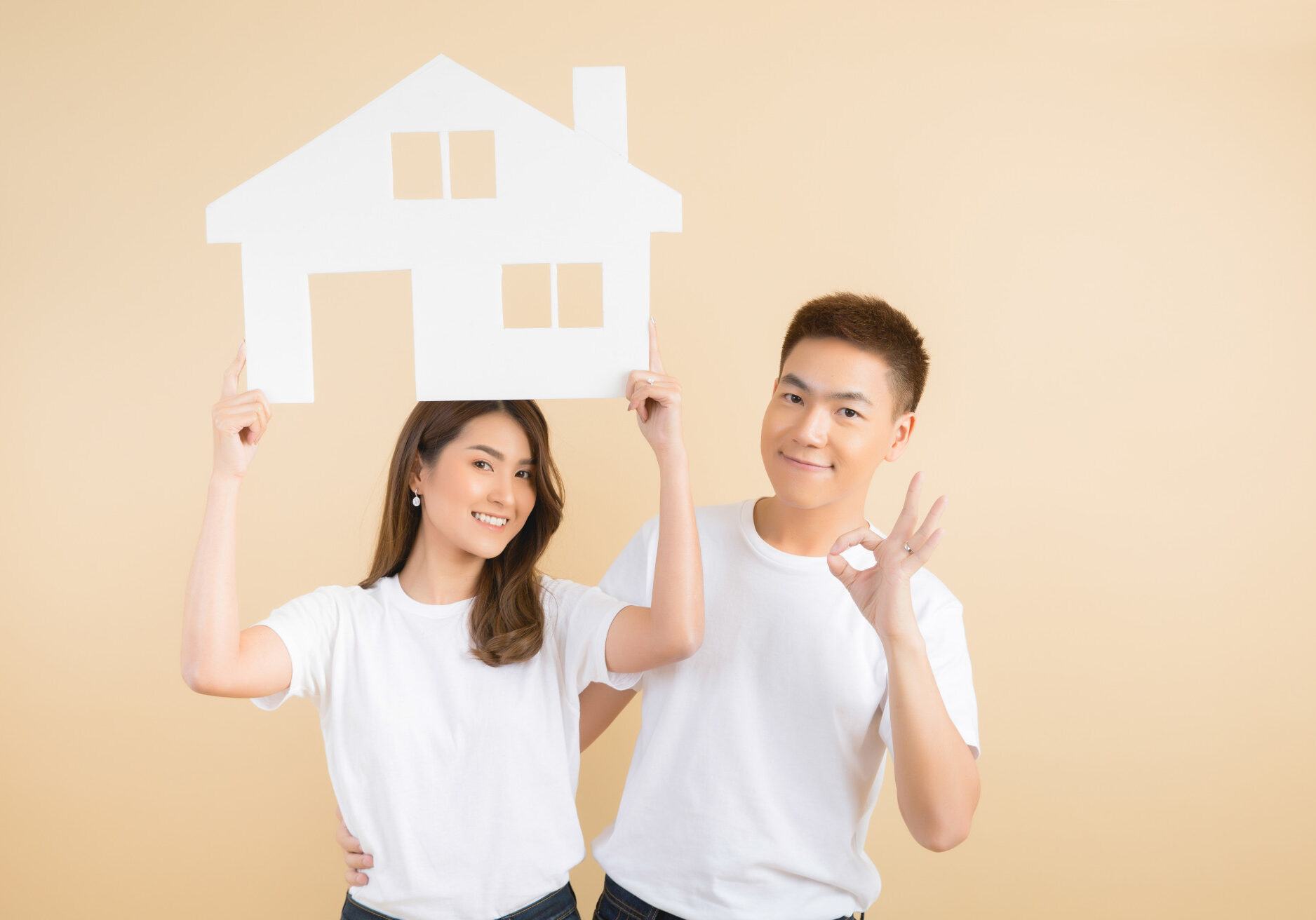 young-happy-asian-couple-presenting-symbols-house
